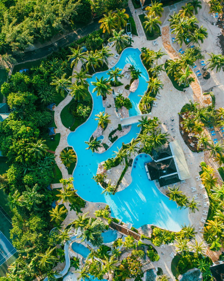 Luxury Cancun resort pool surrounded by tropical palm trees