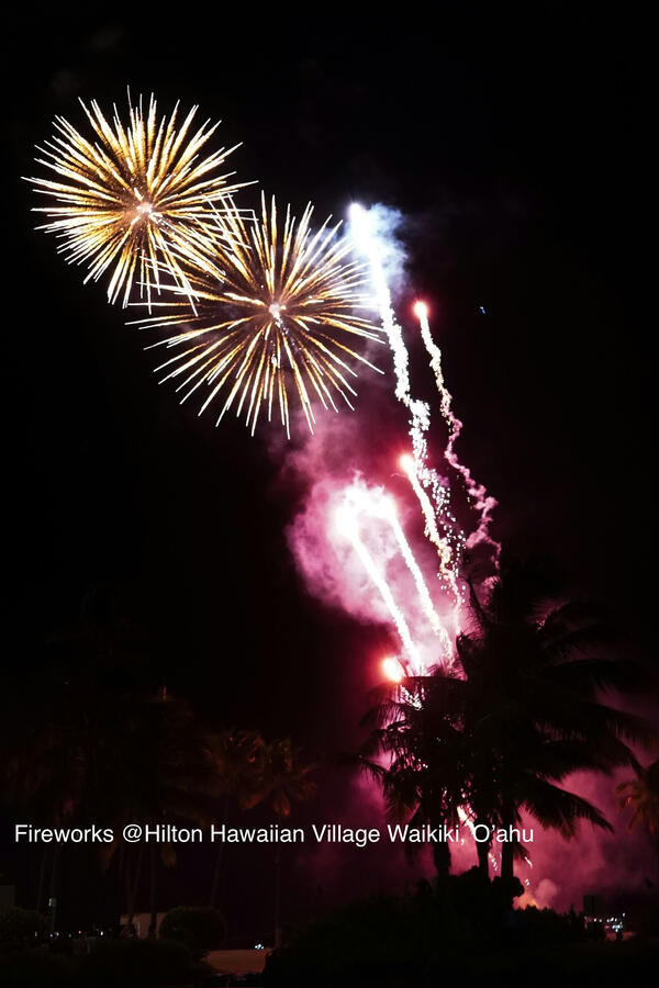 Fireworks over Hilton Hawaiian Village Waikiki resort at night